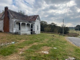 view of property exterior with a lawn