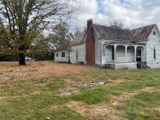 view of side of home with a lawn