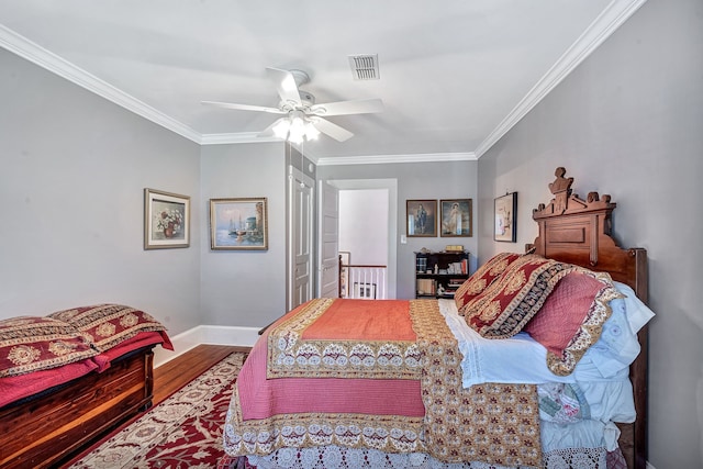 bedroom featuring wood-type flooring, ceiling fan, and crown molding