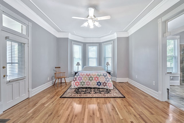 bedroom with ceiling fan, light hardwood / wood-style floors, and multiple windows