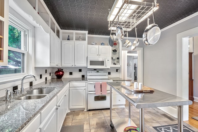 kitchen with white cabinets, sink, white appliances, and ornamental molding