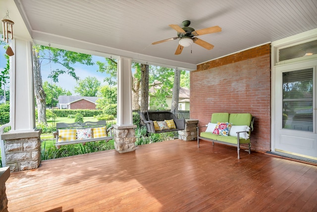 sunroom / solarium featuring ceiling fan