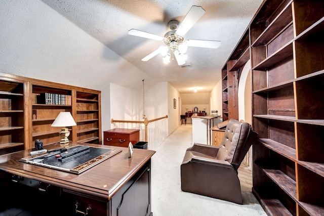 carpeted office with ceiling fan with notable chandelier, a textured ceiling, and vaulted ceiling