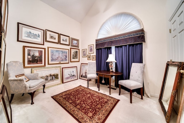 sitting room with carpet and lofted ceiling