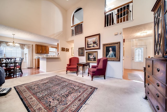 sitting room featuring a high ceiling and an inviting chandelier