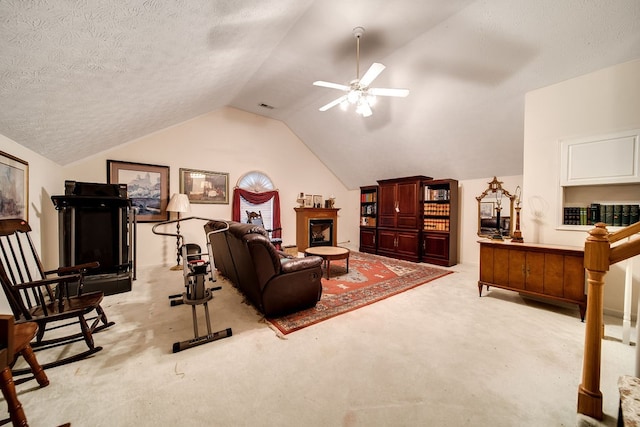 living room featuring a textured ceiling, ceiling fan, light colored carpet, and lofted ceiling