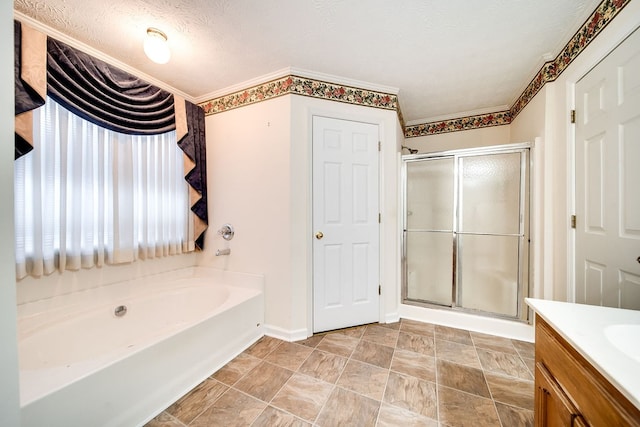 bathroom with vanity, independent shower and bath, and a textured ceiling