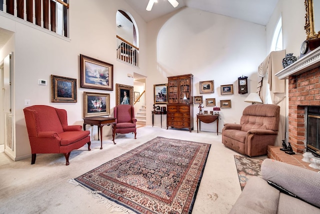 living room featuring carpet, high vaulted ceiling, and a brick fireplace