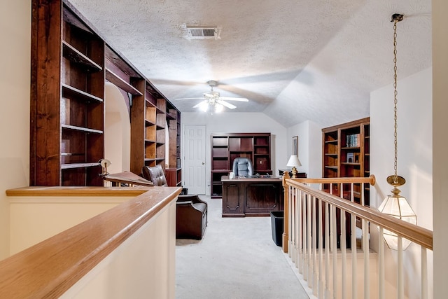 carpeted office featuring a textured ceiling, ceiling fan, and lofted ceiling