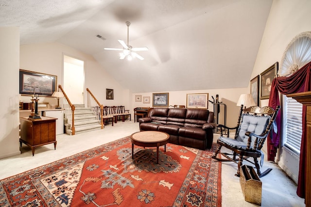 living room with a textured ceiling, light colored carpet, ceiling fan, and lofted ceiling