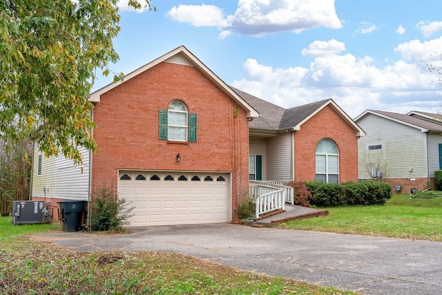 view of front of house with a front lawn, cooling unit, and a garage