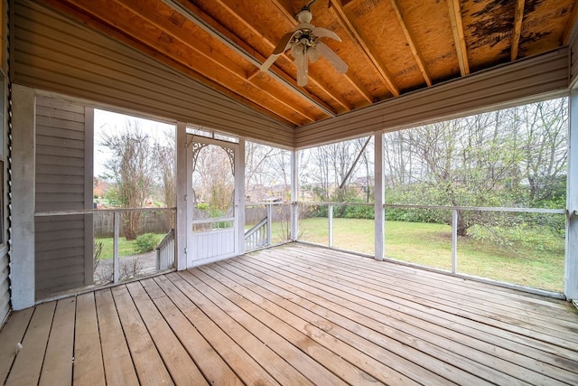 unfurnished sunroom with vaulted ceiling, ceiling fan, and plenty of natural light