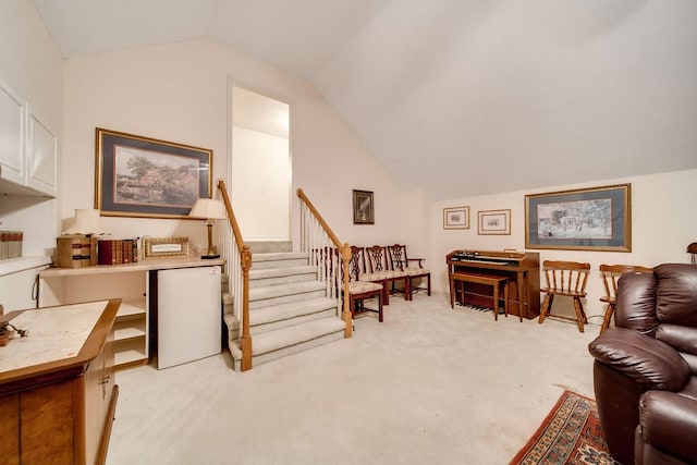 carpeted living room featuring lofted ceiling