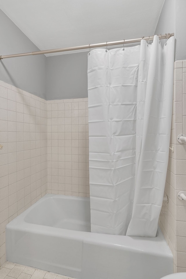 bathroom featuring tile patterned flooring and shower / bath combo