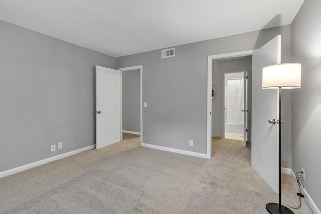 unfurnished bedroom with light carpet