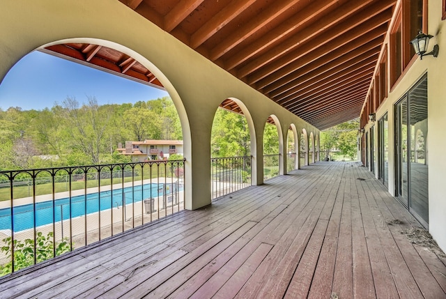 wooden terrace with a fenced in pool