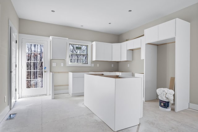 kitchen featuring white cabinetry, plenty of natural light, and a kitchen island