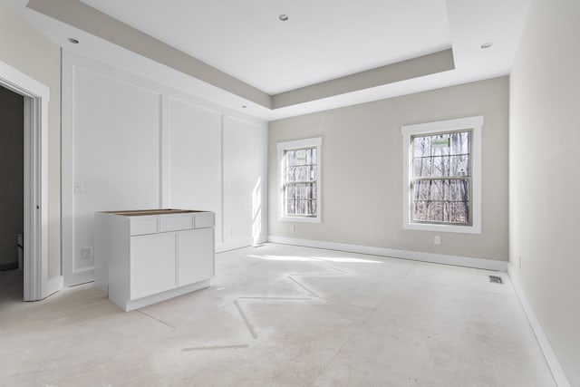 spare room featuring a raised ceiling