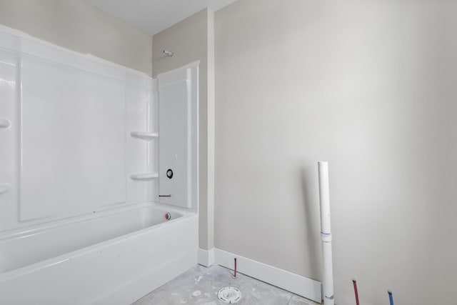 bathroom featuring shower / tub combination and concrete floors