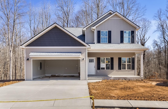 view of front of property featuring covered porch, an attached garage, concrete driveway, and board and batten siding