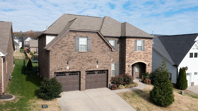 view of front of house featuring a garage and a front lawn