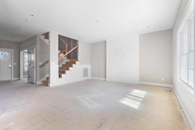 unfurnished living room with a wealth of natural light