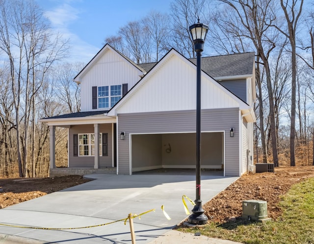 view of front of house with a garage, board and batten siding, and driveway