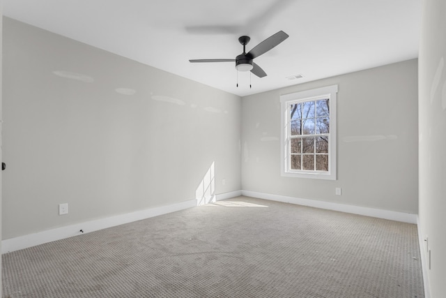 unfurnished room with visible vents, baseboards, a ceiling fan, and carpet flooring