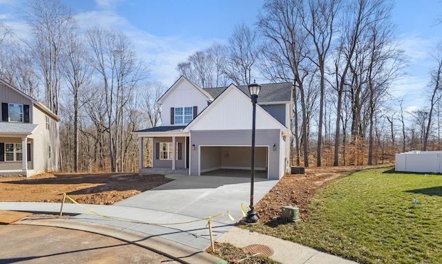 view of front of house with a front yard, a garage, and driveway