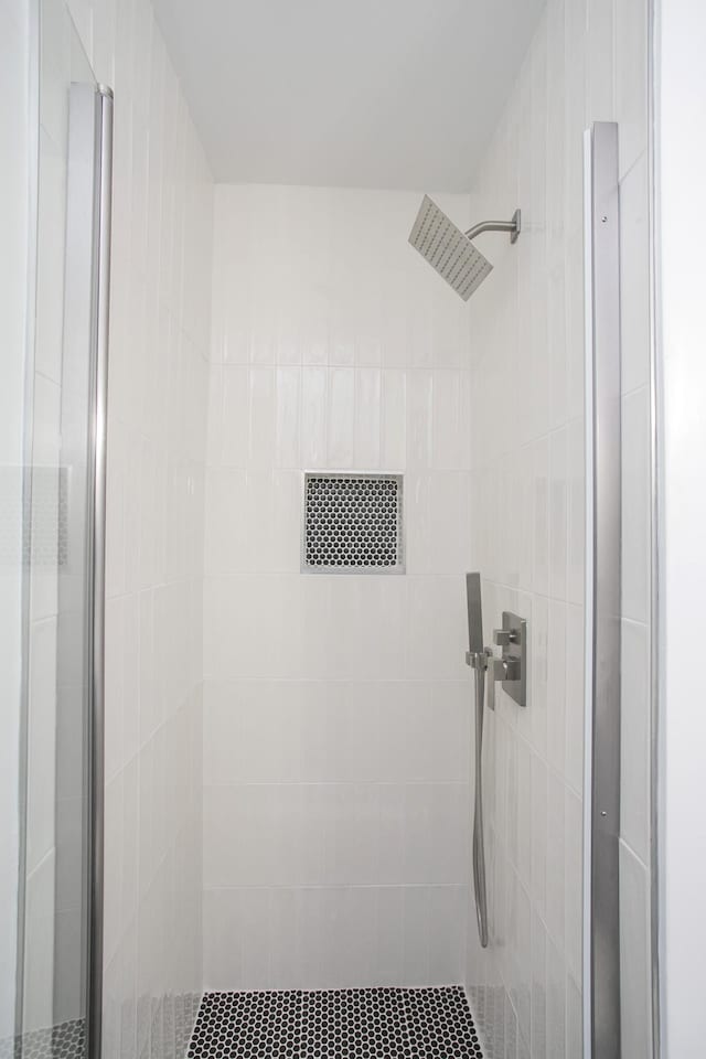 bathroom with a tile shower