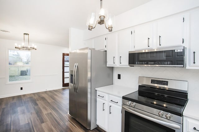 kitchen featuring pendant lighting, decorative backsplash, dark hardwood / wood-style flooring, and stainless steel appliances