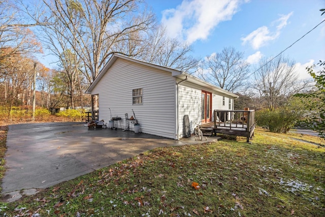 view of home's exterior featuring a wooden deck