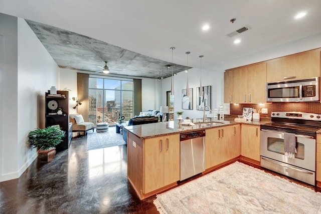 kitchen featuring kitchen peninsula, light brown cabinetry, backsplash, stainless steel appliances, and sink