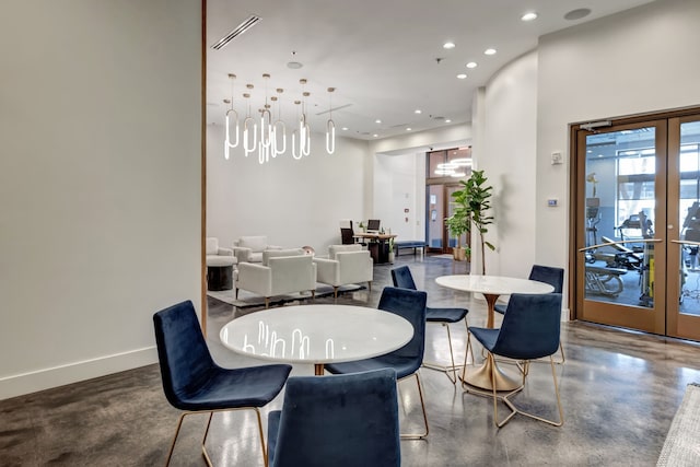 dining area with french doors and concrete flooring