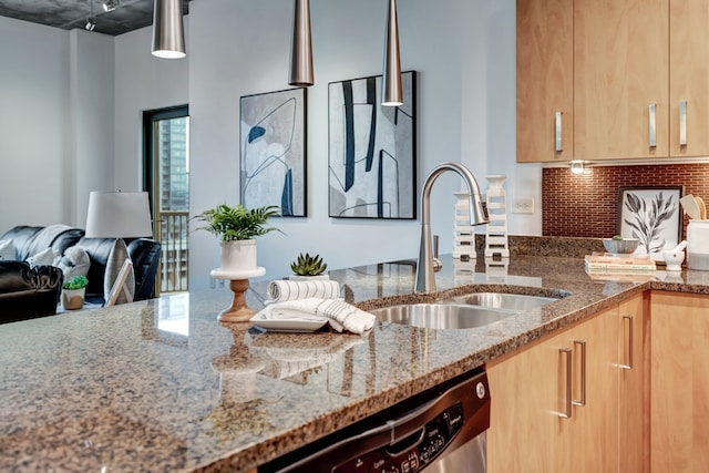 kitchen with sink, hanging light fixtures, stainless steel dishwasher, decorative backsplash, and light stone countertops