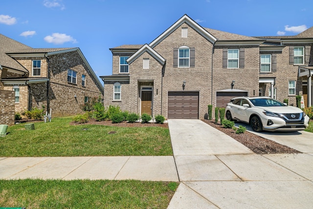 townhome / multi-family property with a garage and a front lawn