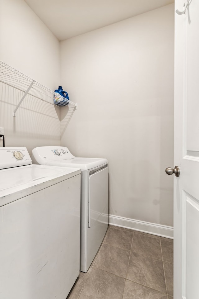 clothes washing area with tile patterned floors and washing machine and dryer