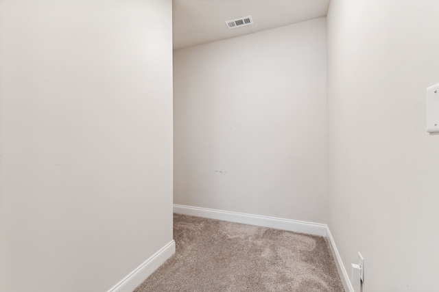 unfurnished room featuring light colored carpet