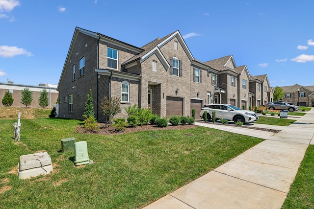 view of front of home with a front yard and a garage