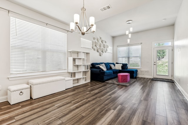 living room with wood-type flooring and a chandelier