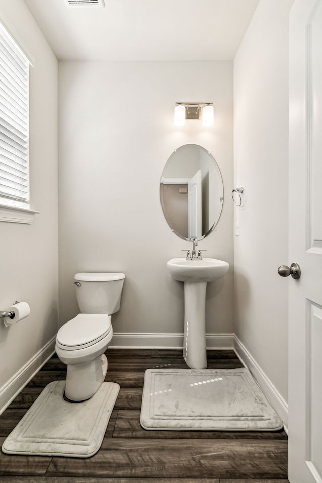 bathroom featuring hardwood / wood-style floors and toilet