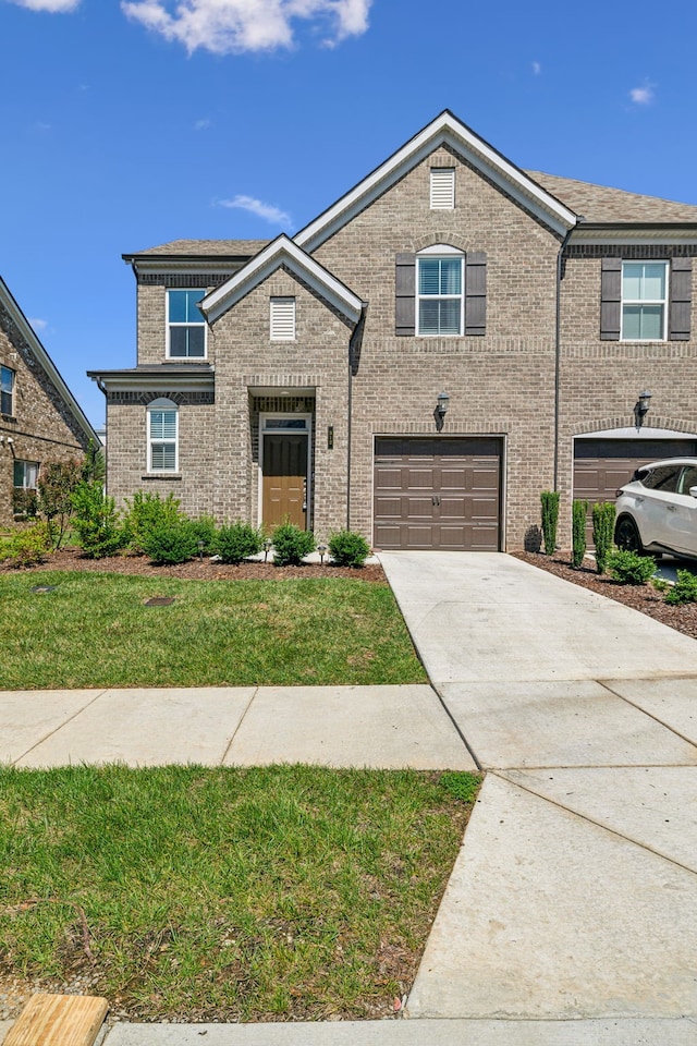 view of front facade featuring a garage and a front lawn