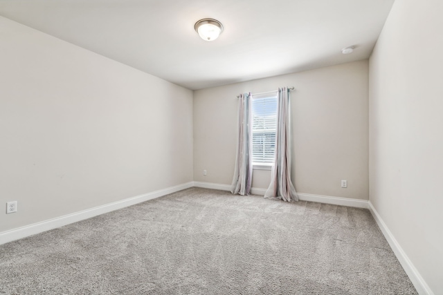 unfurnished room featuring light colored carpet