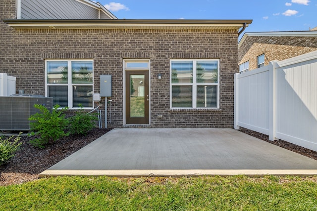 doorway to property featuring a patio area and central AC unit