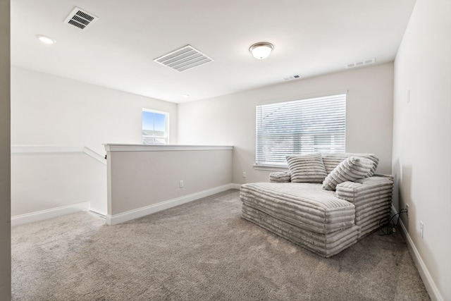 sitting room featuring carpet and a healthy amount of sunlight