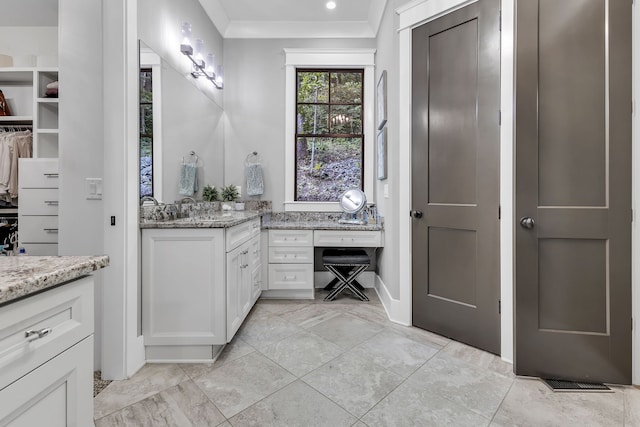 bathroom featuring crown molding and vanity