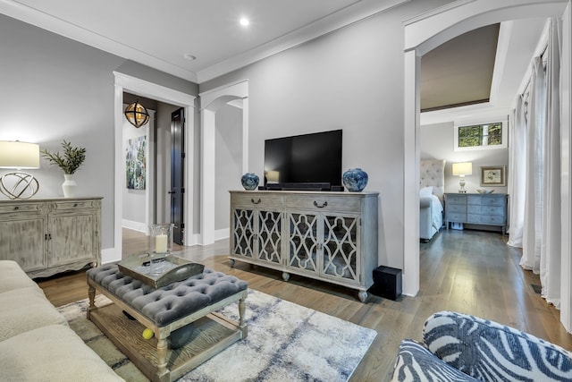 living room featuring hardwood / wood-style flooring and ornamental molding