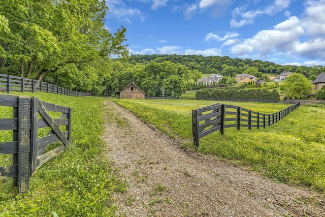 surrounding community featuring a rural view and an outdoor structure