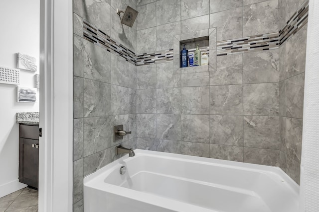 bathroom with tile patterned flooring, vanity, and tiled shower / bath combo