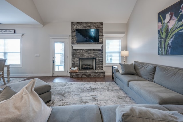 living room with a fireplace, hardwood / wood-style flooring, and lofted ceiling